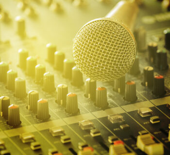 Microphones,with,audio,mixers,in,the,control,room,of,the